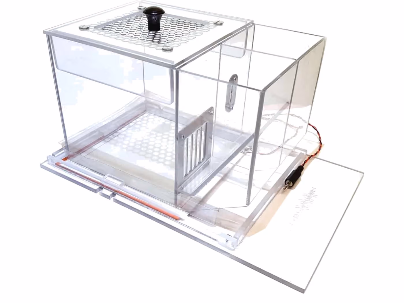 A clear acrylic operant chamber with a perforated floor, a lever panel and a sliding door