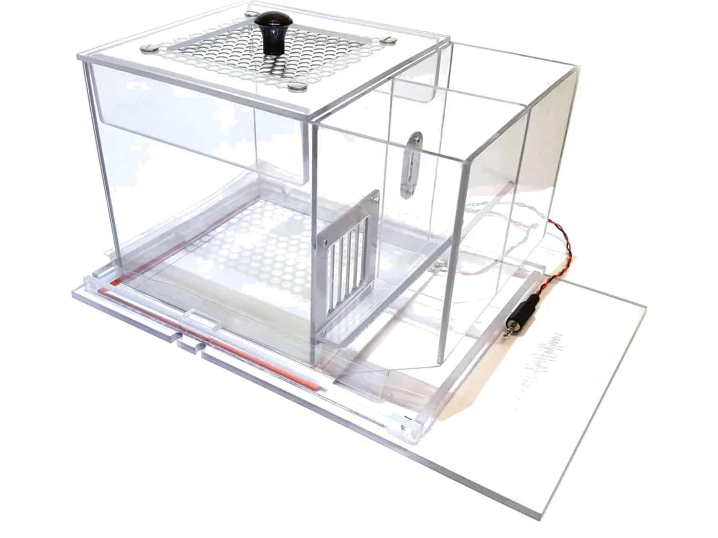 A clear acrylic operant chamber with a perforated floor, a lever panel and a sliding door
