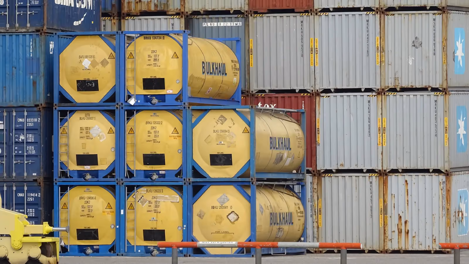 Stacked tank containers at the Port of Rotterdam; boxes mark five container numbers read from the tanks and a box container, including BRKU 124696 4 and BLKU 250561.
