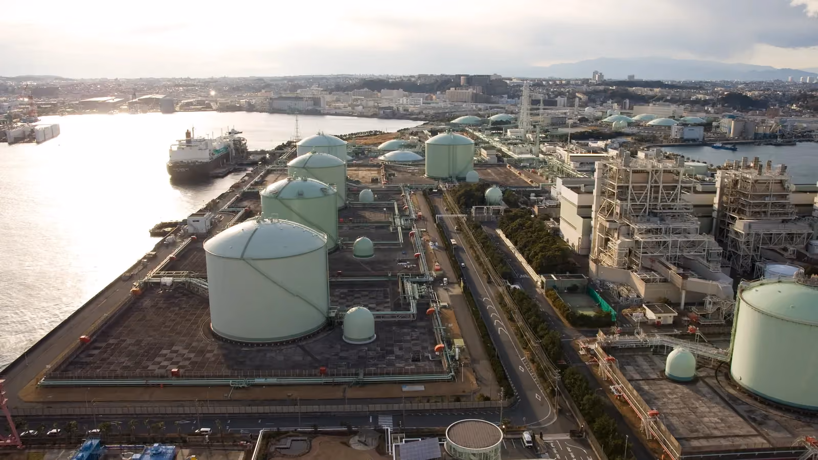 A ship berthed beside the storage tanks of the Negishi LNG Terminal in Yokohama, Japan; boxes and outlines mark the ship and five storage tanks.