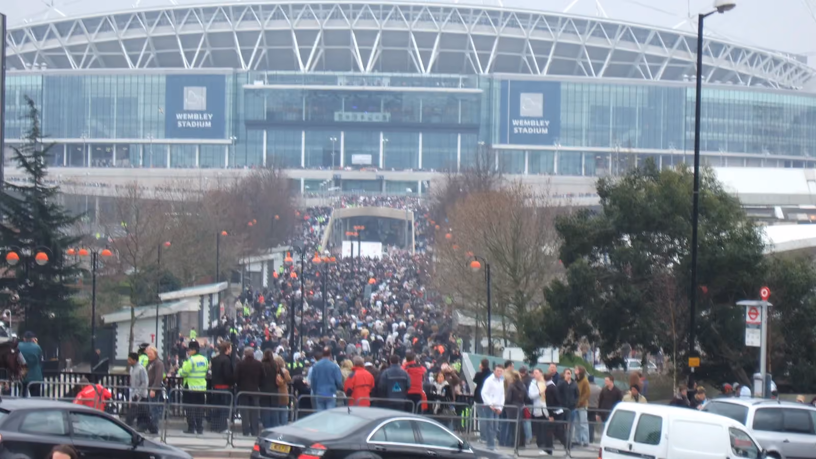 A large crowd streams along the approach to Wembley Stadium; boxes mark 30 people at the near edge of the crowd.