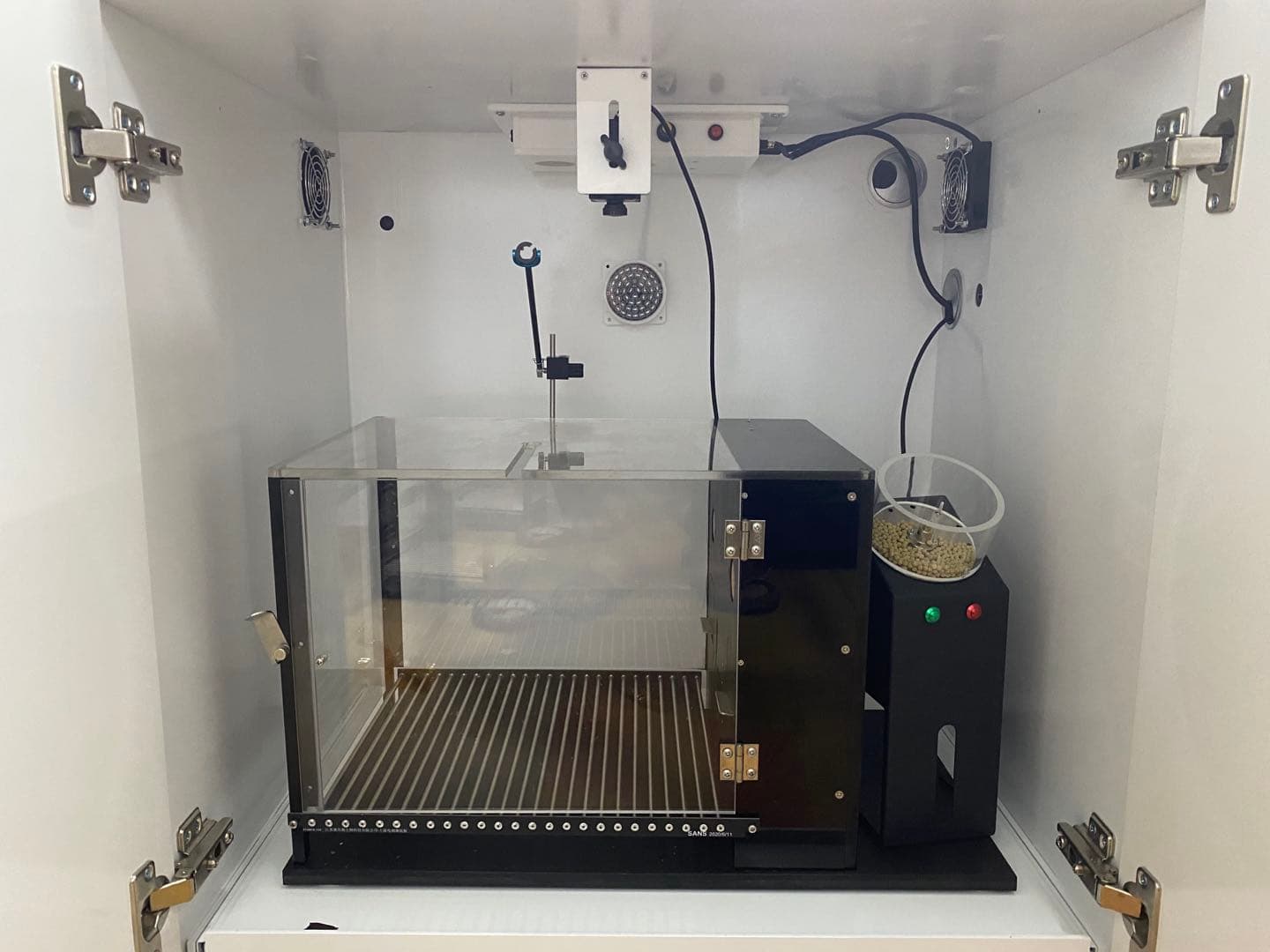 Real operant conditioning chamber with pellet dispenser and shock grid inside sound enclosure