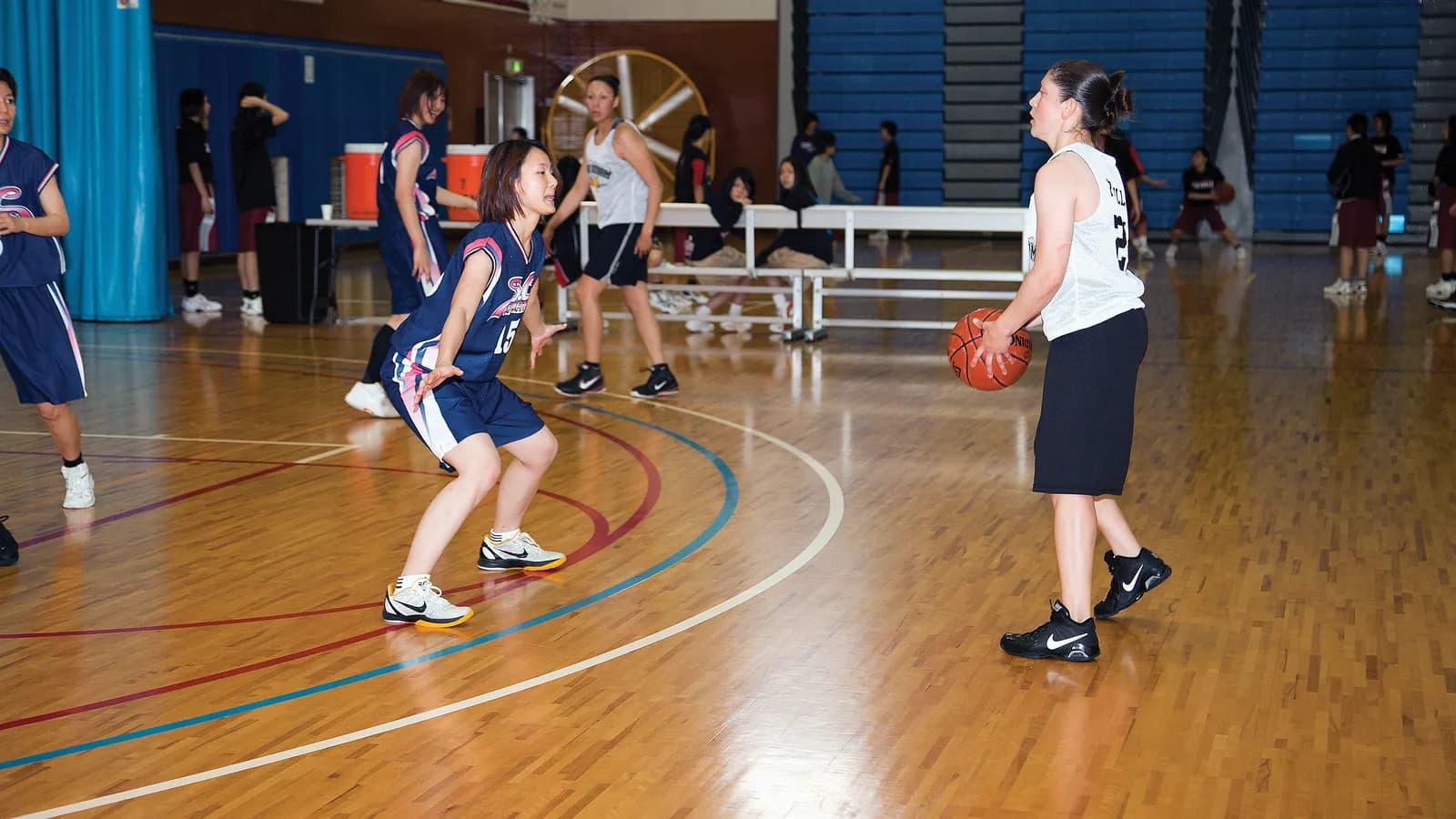 Players in a gym during a practice game; boxes mark each player on and around the court and the ball.
