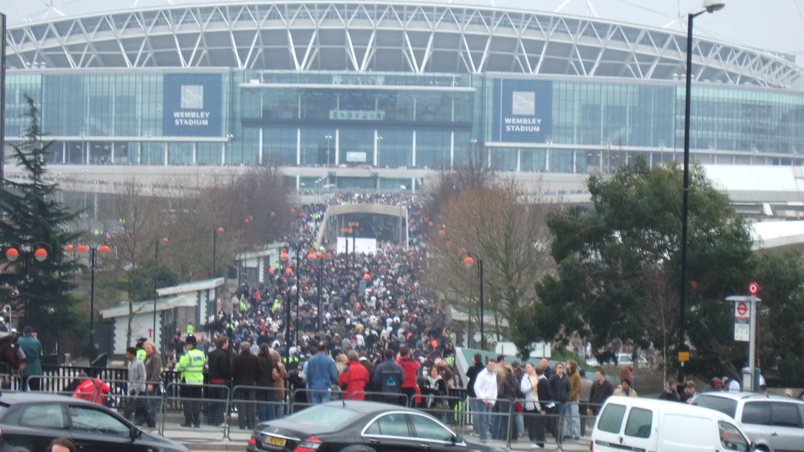 A large crowd streams along the approach to Wembley Stadium; boxes mark 30 people at the near edge of the crowd.