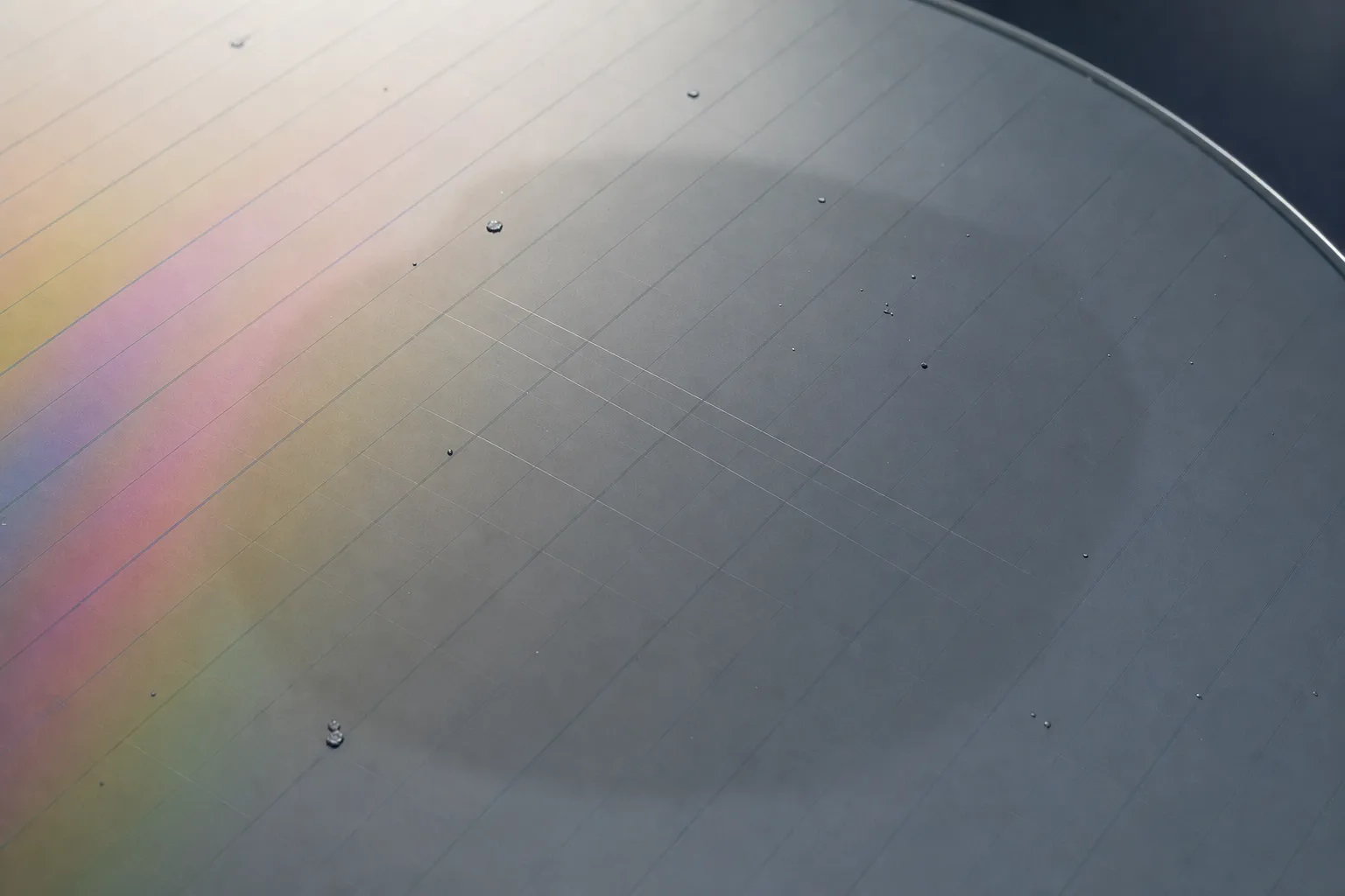 Illustrative polished wafer surface with fine scratches and isolated particles for CMP inspection