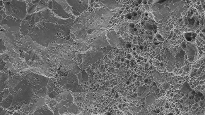 SEM-like fracture surface with ductile dimples and cleavage features