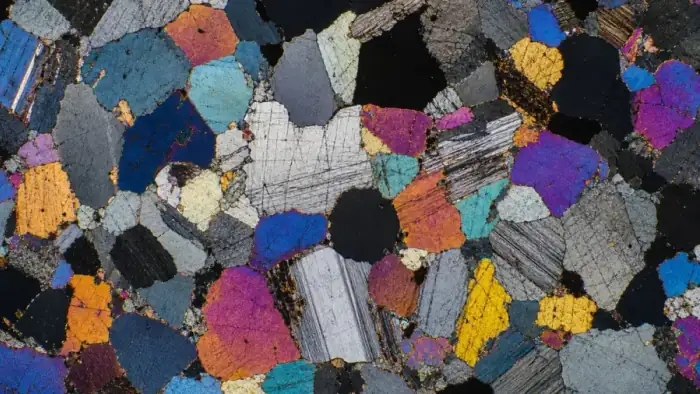 Polarized petrographic thin section with colorful mineral grains