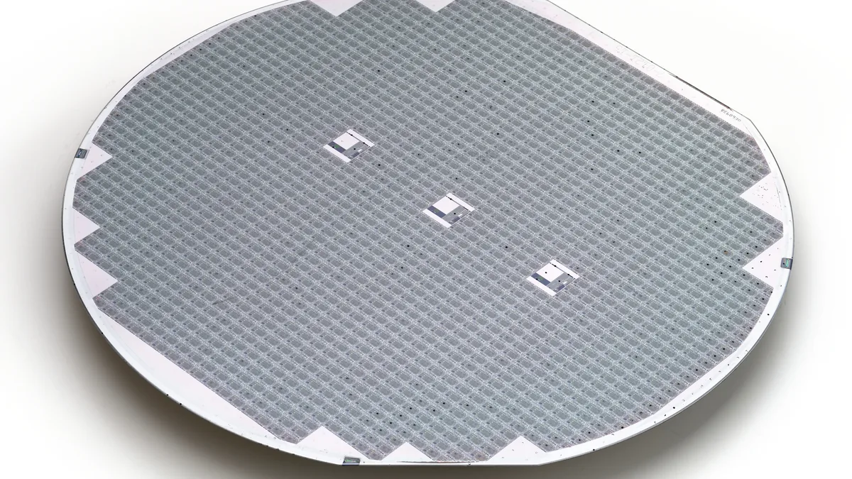 Processed 150 mm silicon wafer with a grid of dies and ink-marked defective dies