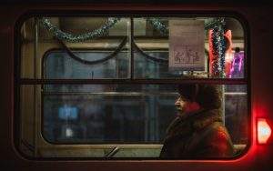 Old man siting in a train.