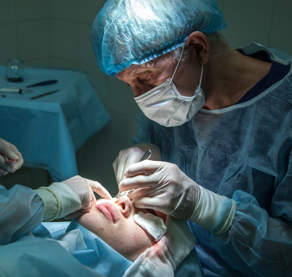 Doctor inspecting eye during surgery - Plastic Surgery - News article featured image