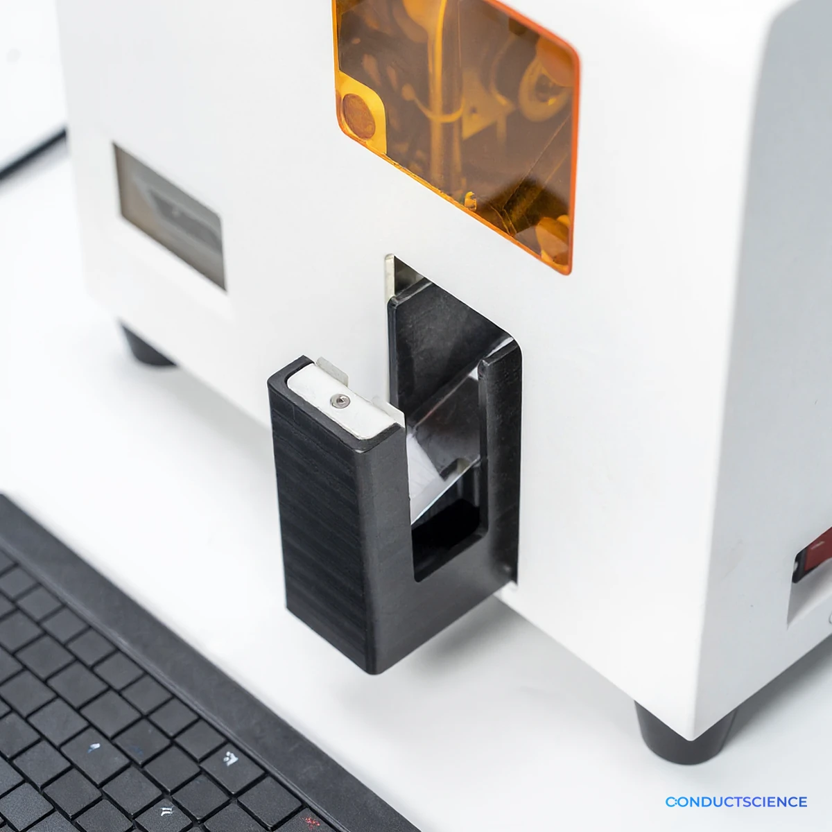 Close-up of the slide output magazine and amber viewing window